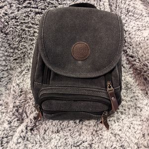 Worn gray denim mini black backpack/crossbody bag